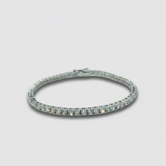 Silver bracelet with clear stones on a light gray background