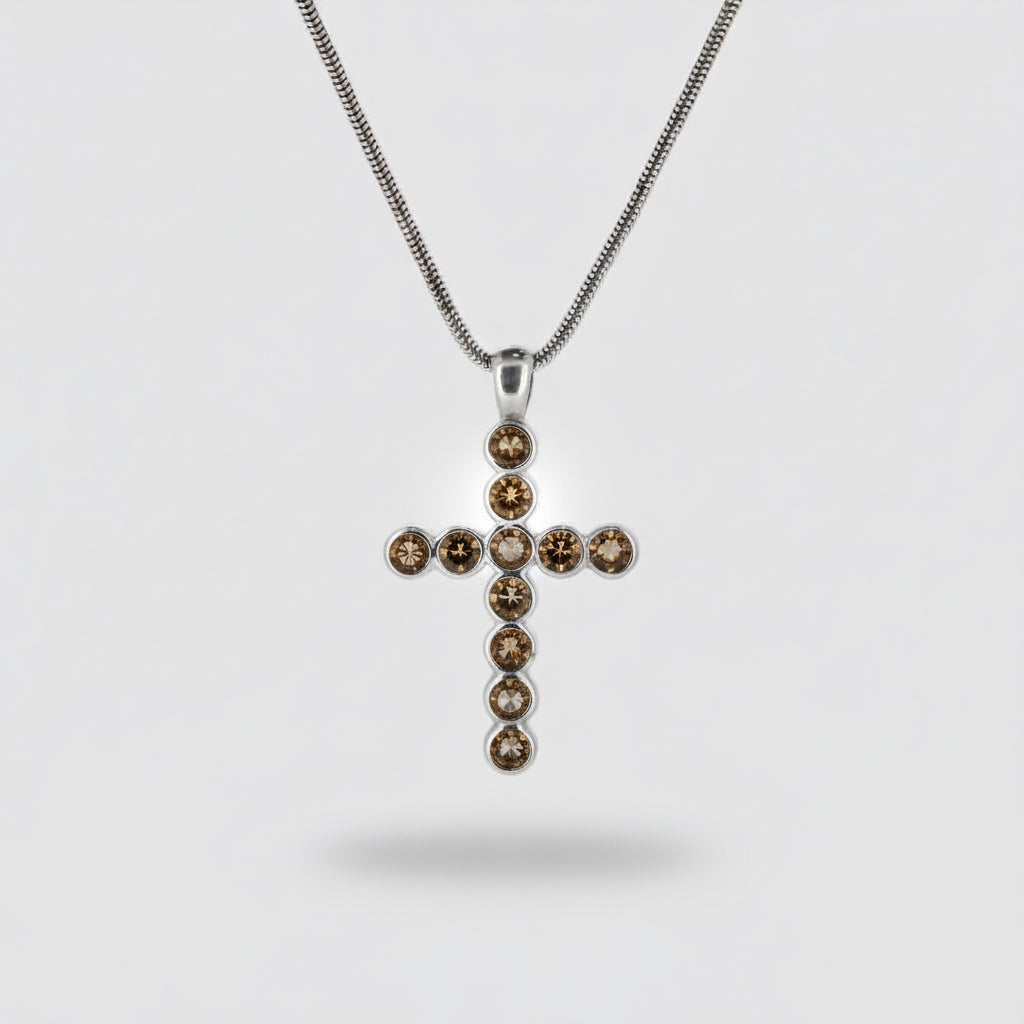 Silver cross pendant with purple gemstones on a white background