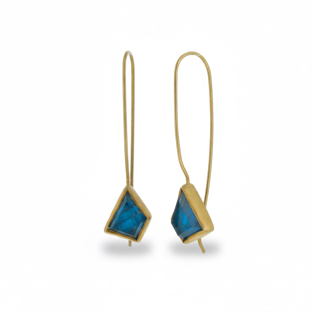Pair of gold earrings with blue triangular stones on a white background