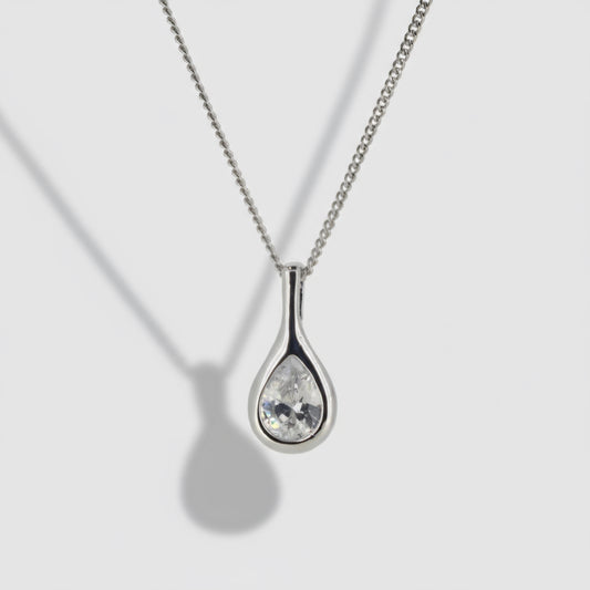 Silver teardrop-shaped pendant necklace on a light gray background