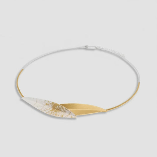 Necklace with gold and white leaf-like pendants on a white background