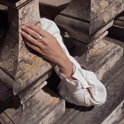 Hand with a ring on a stone staircase