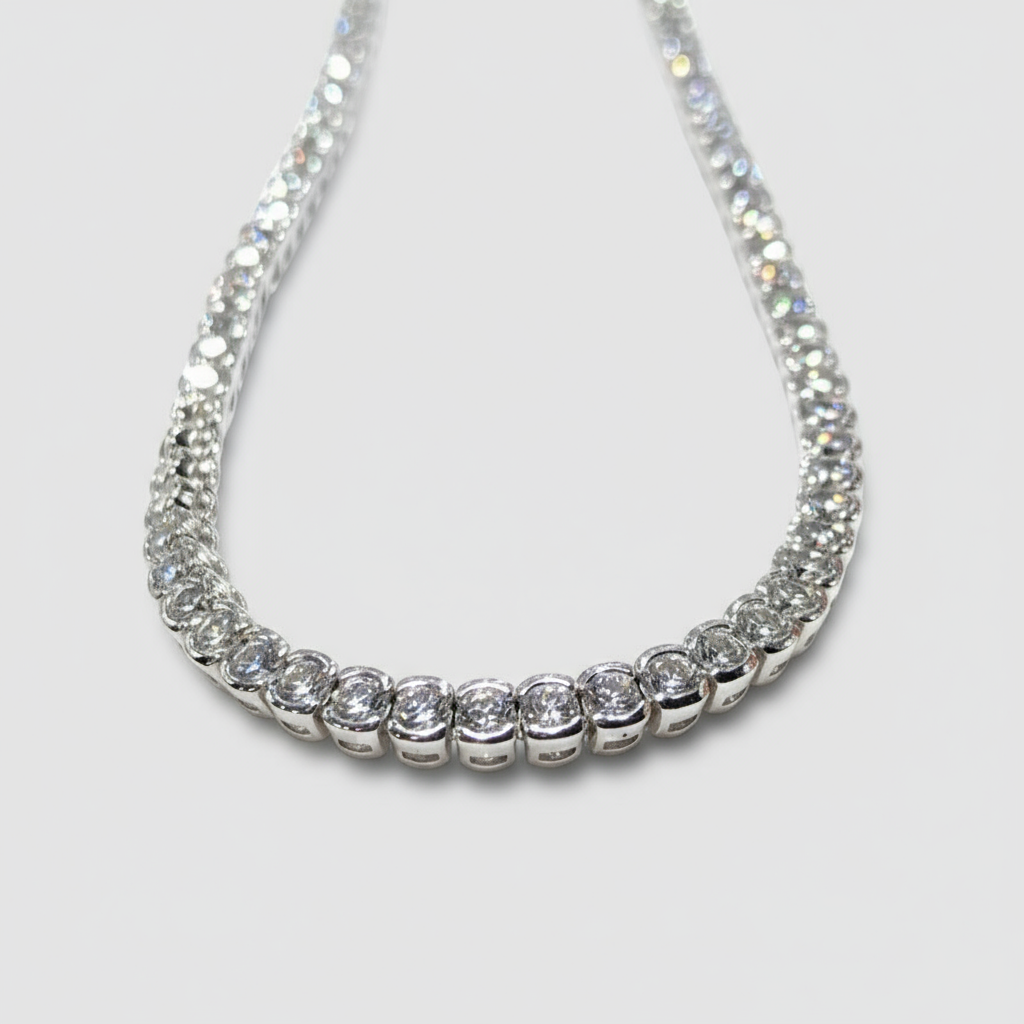 Silver necklace with clear stones on a light gray background