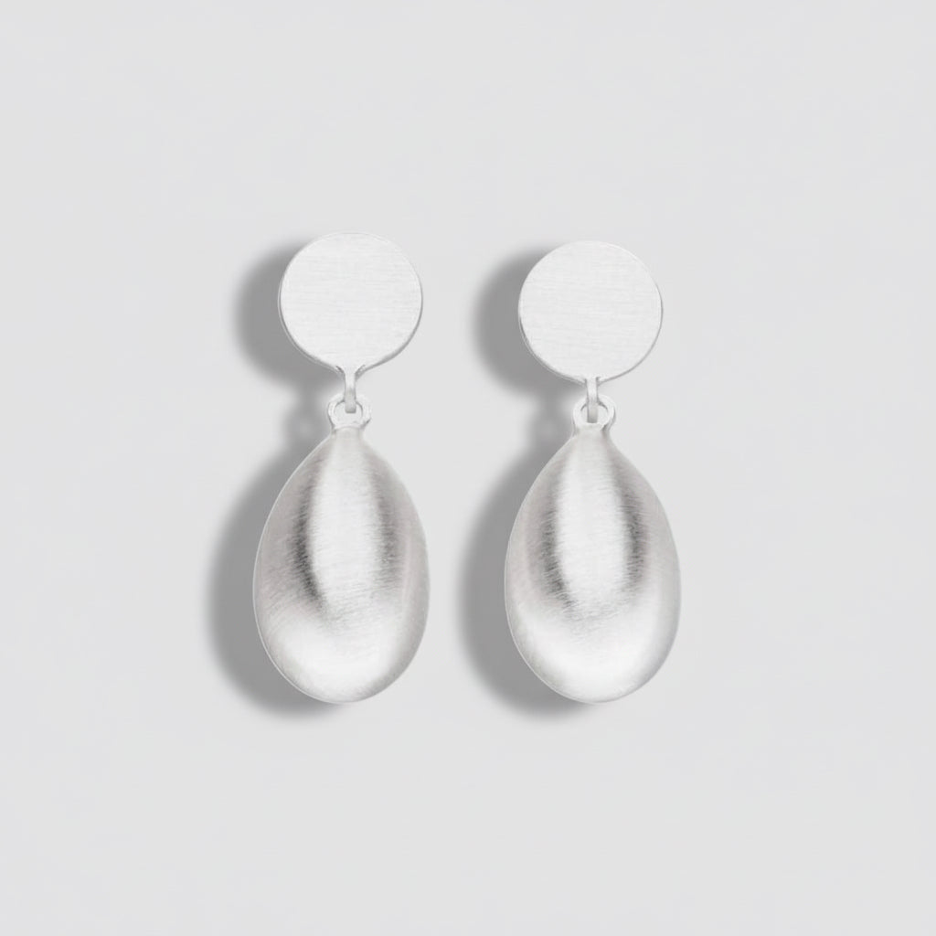 Pair of silver teardrop earrings on a white background