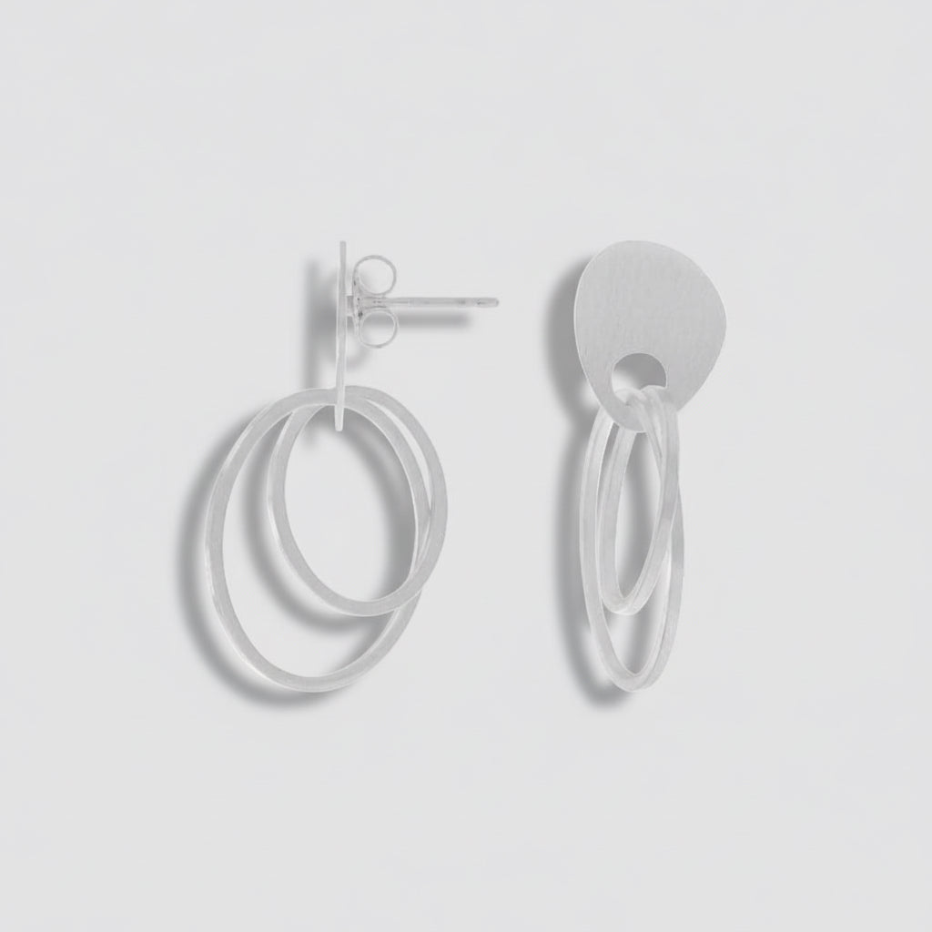 Pair of silver hoop earrings on a white background