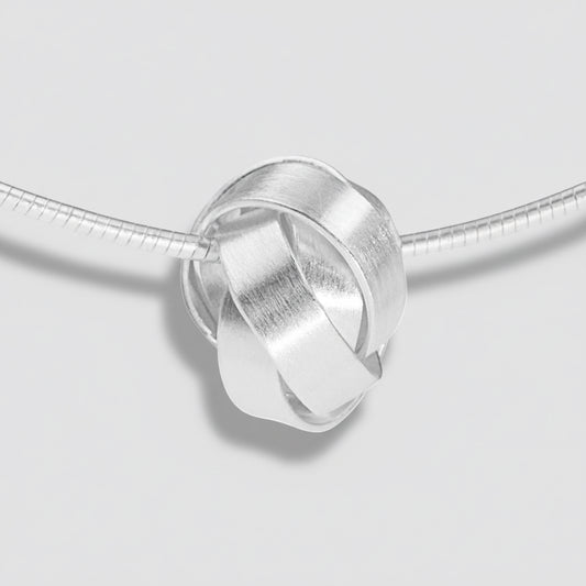 Silver interlocking ring charm on a white background