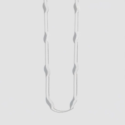 Silver necklace with small pendants on a white background