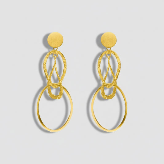 Gold earrings with circular design on a white background