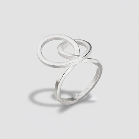 Silver ring with a double loop design on a white background