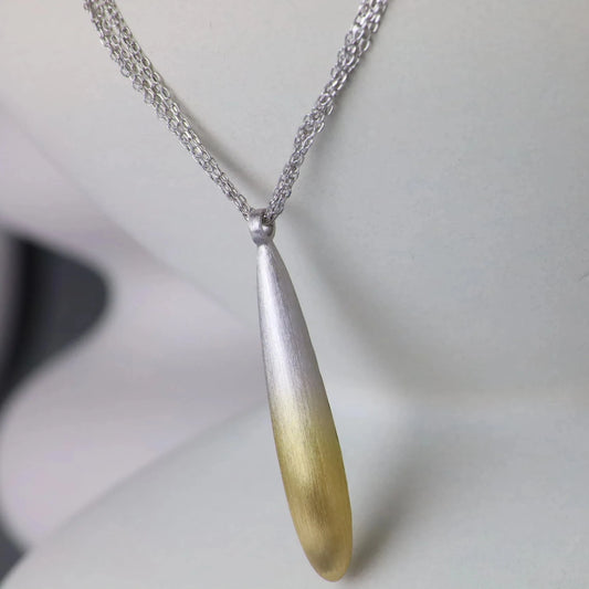 Necklace with a teardrop-shaped pendant on a mannequin bust.