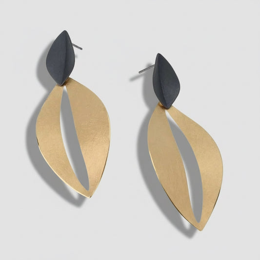 Pair of gold and black earrings on a white background