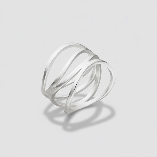 Silver ring with three intertwined loops on a white background