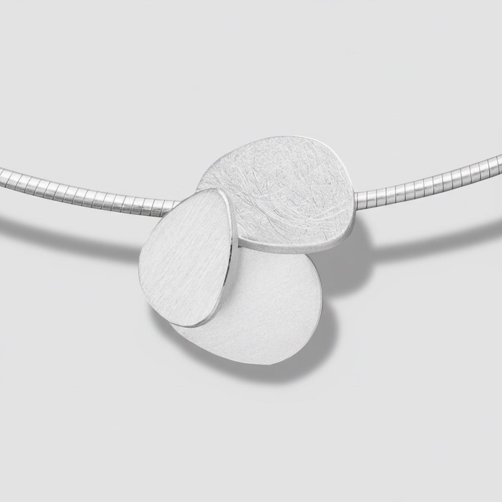Necklace with three round pendants on a white background.