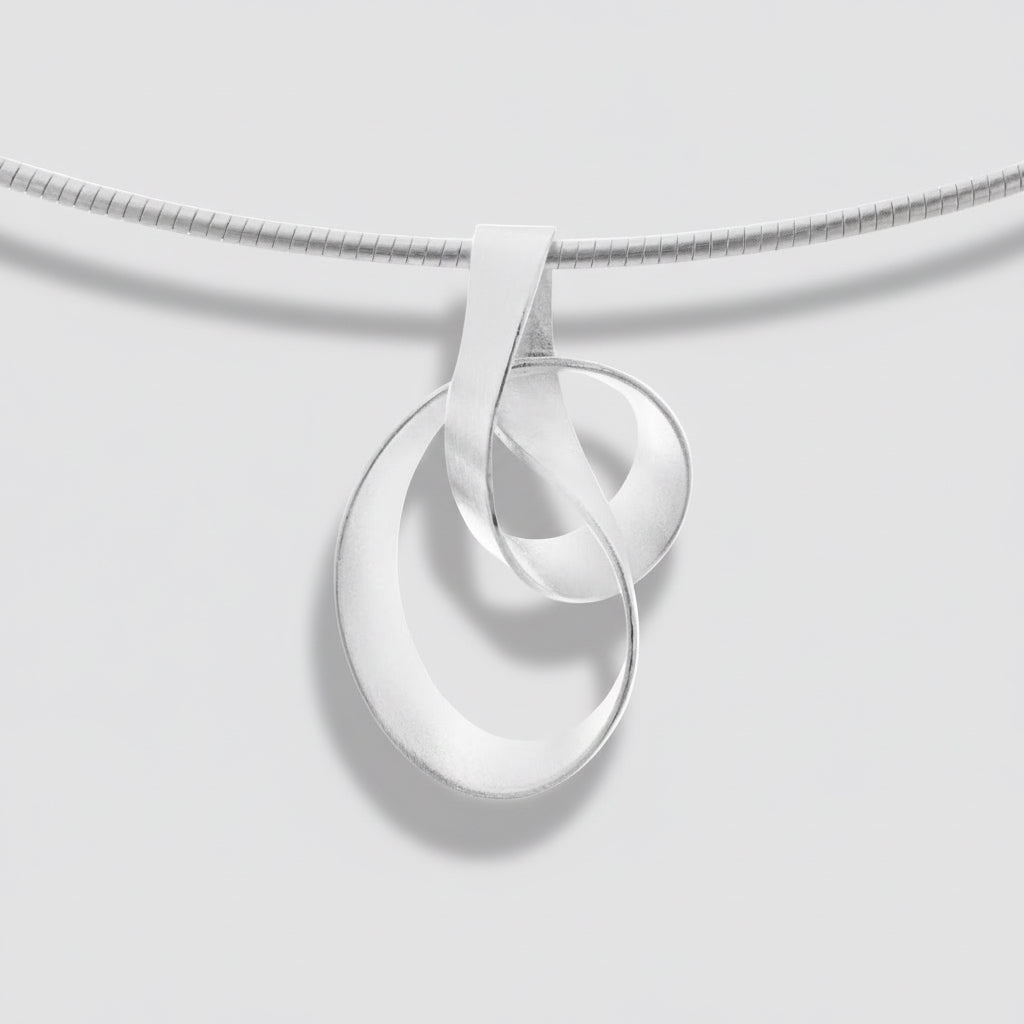 Silver necklace with a unique pendant on a white background