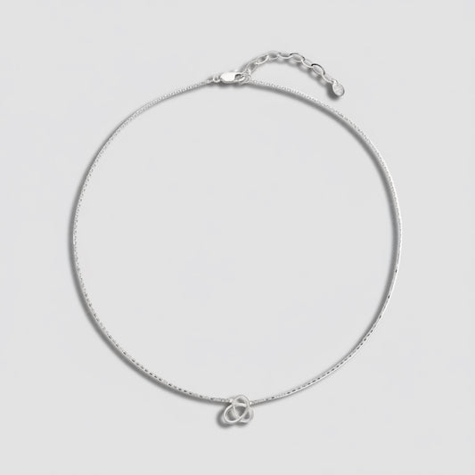 Silver necklace with a double heart pendant on a white background