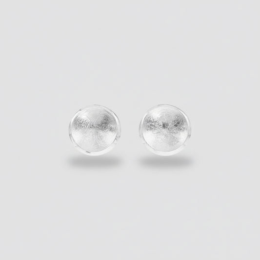 Pair of silver round earrings on a white background